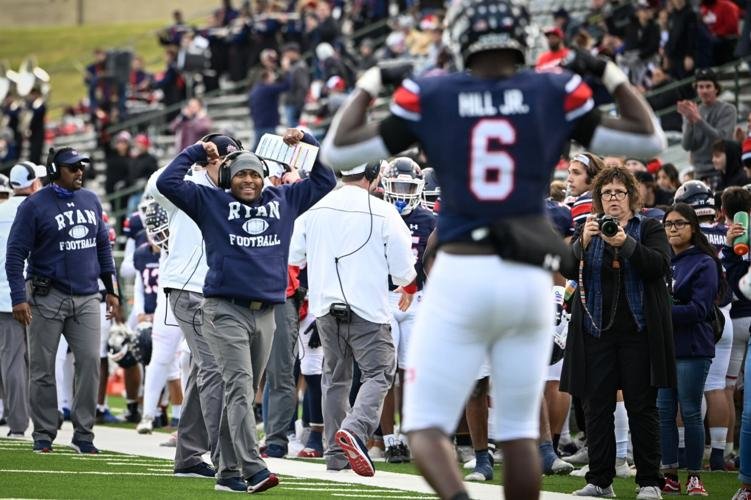Denton Ryan offensive coordinator Lonnie Teagle flexes his muscles with Anthony Hill Jr. after Hill scored a touchdown against Longview at Mesquite Memorial Stadium. Teagle was named Paetow’s head football coach on Wednesday.